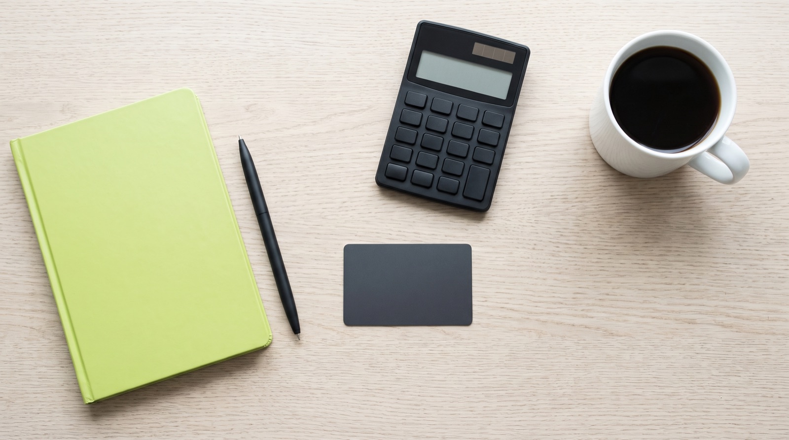 A payment card, a calculator and a notebook laid out on a desk, showing the two ways to borrow side by side.
